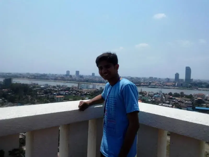 Nikunj on a terrace overlooking Phnom Penh and the river