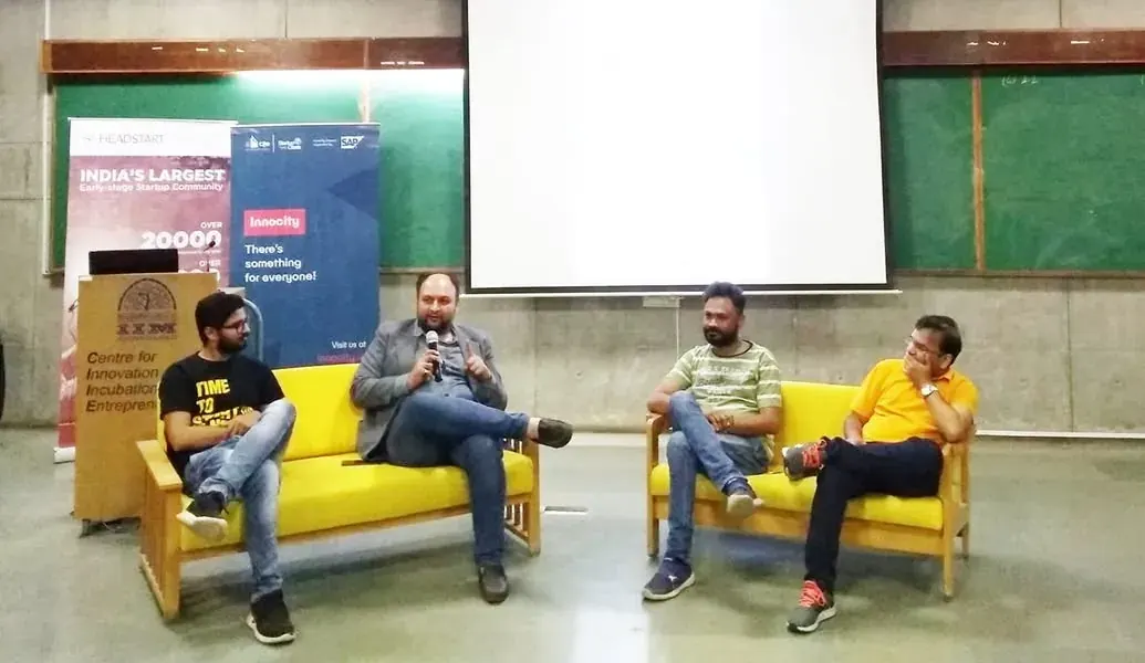 A panel discussion on a yellow sofa at Startup Saturday