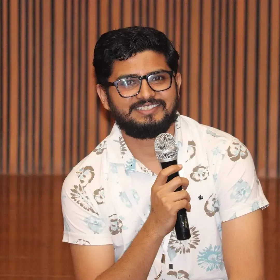 Nikunj holding a mic while hosting a GDG Cloud Ahmedabad event