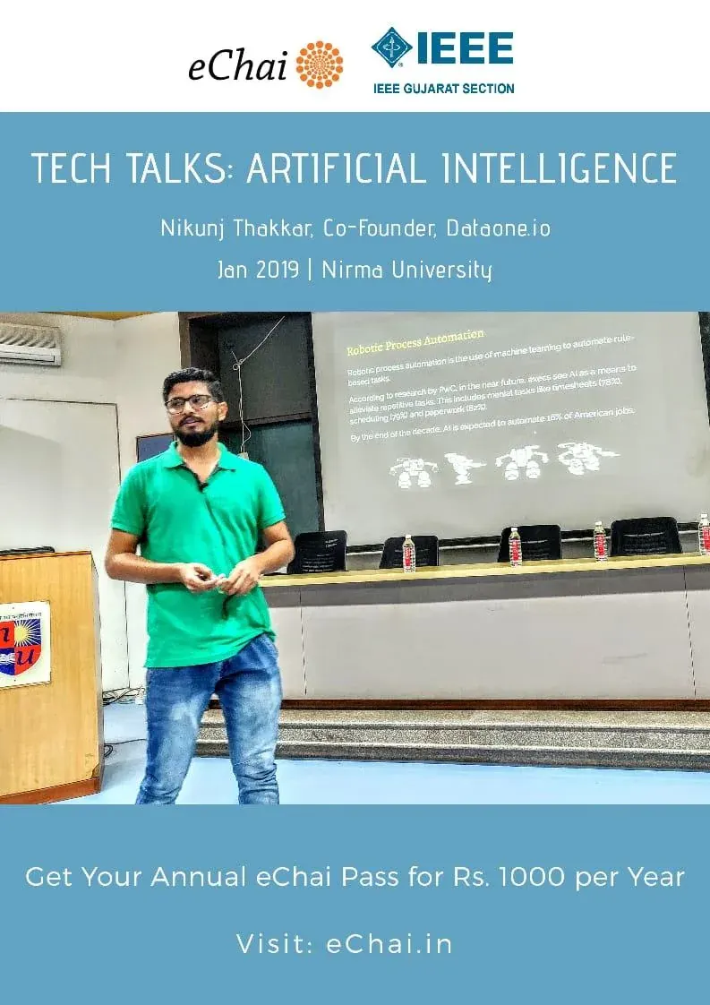 Nikunj speaking on stage at Nirma University, slides on artificial intelligence behind him