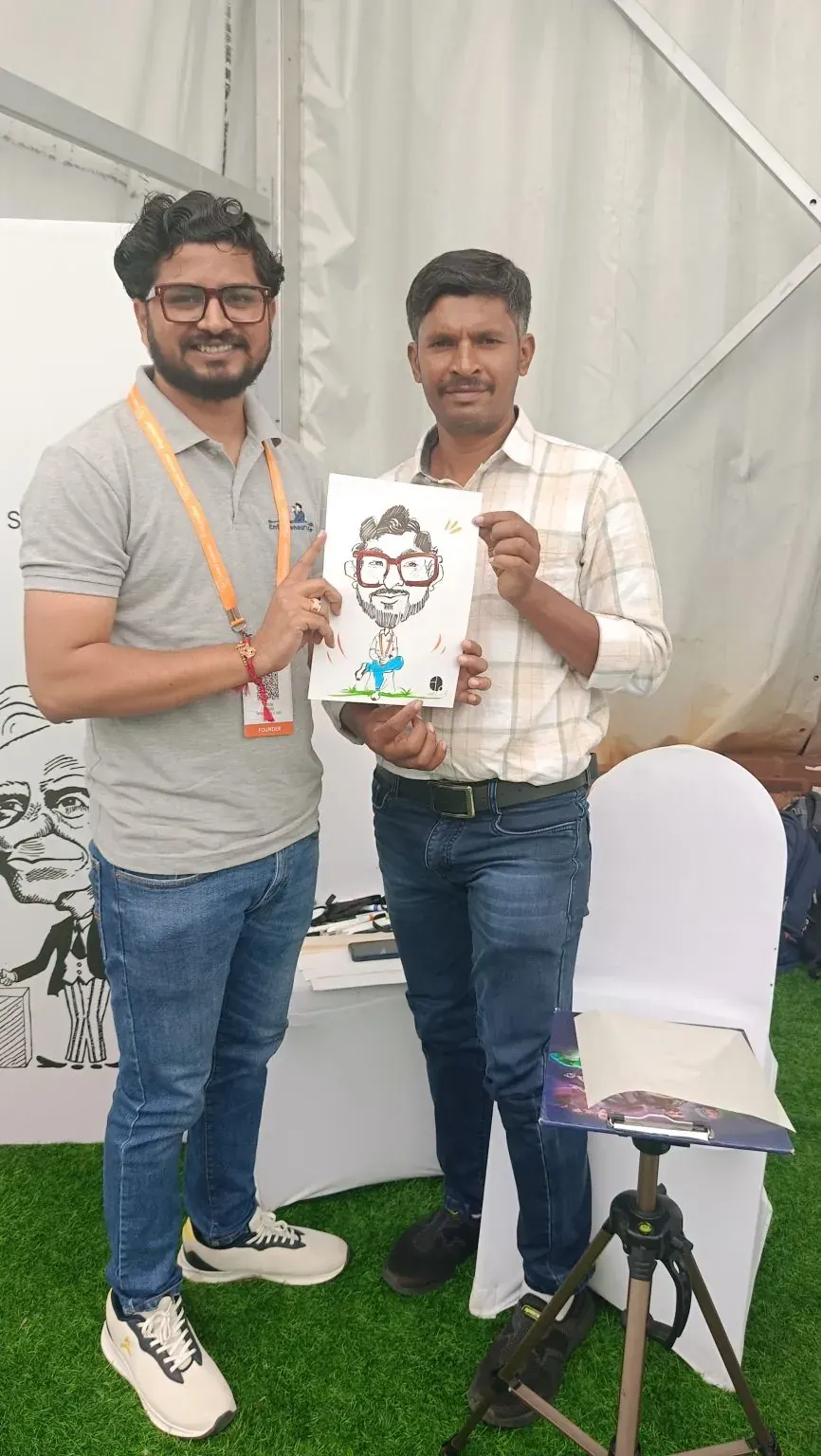 Nikunj holding a caricature of himself at SAASCON