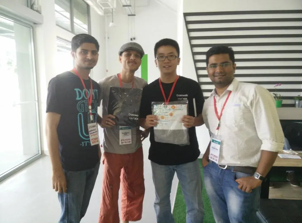Nikunj and friends presenting a T-shirt at FOSSASIA 2015