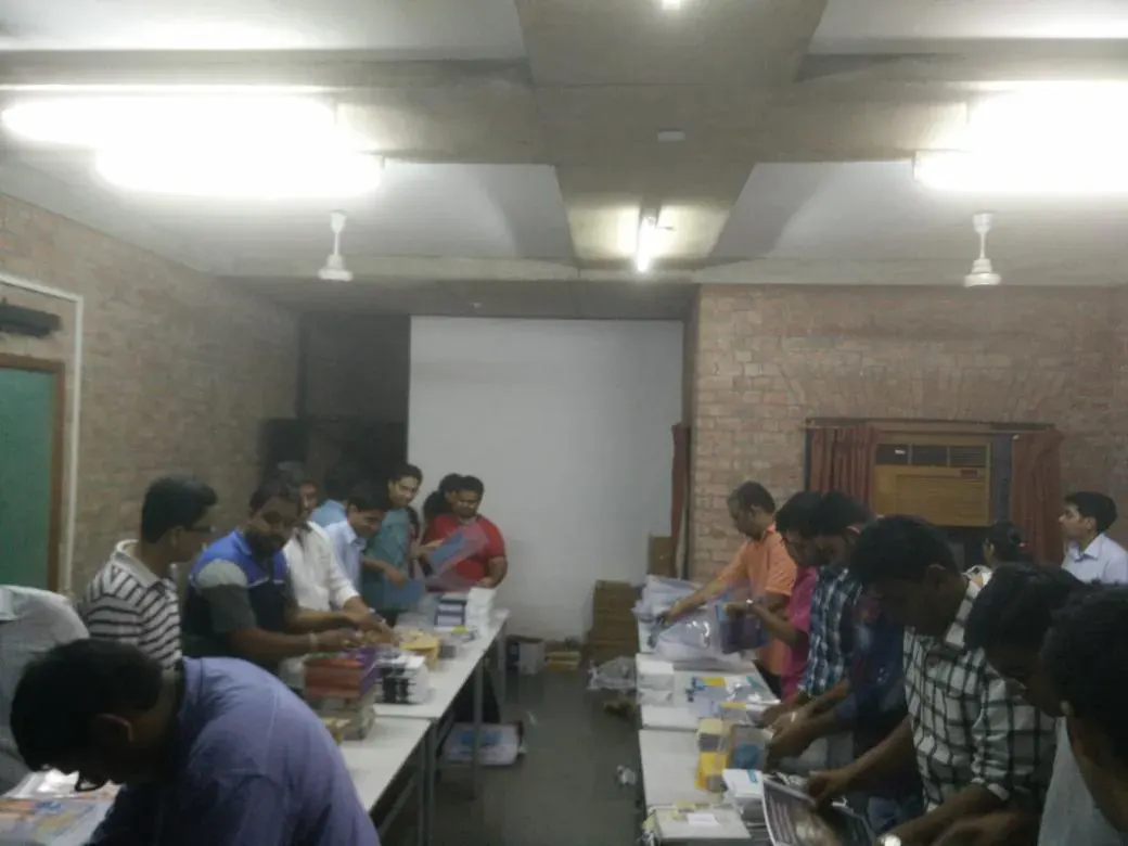 Volunteers preparing delegate kits at a table